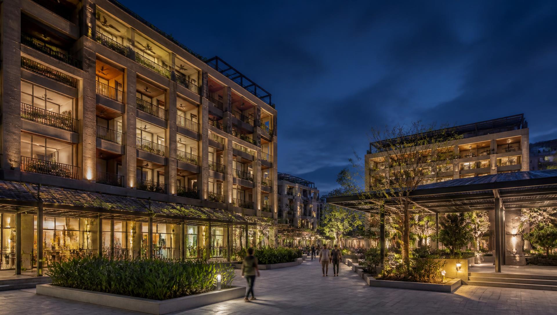 Contemporary mixed-use residential development at blue hour with solar integrated into the architecture